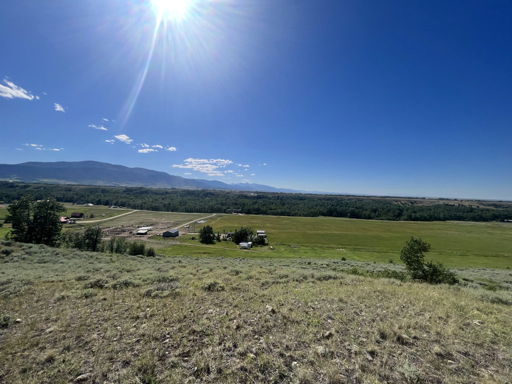 The Bench: sun over the ranch at East Bench Overlook near Red Lodge, Montana