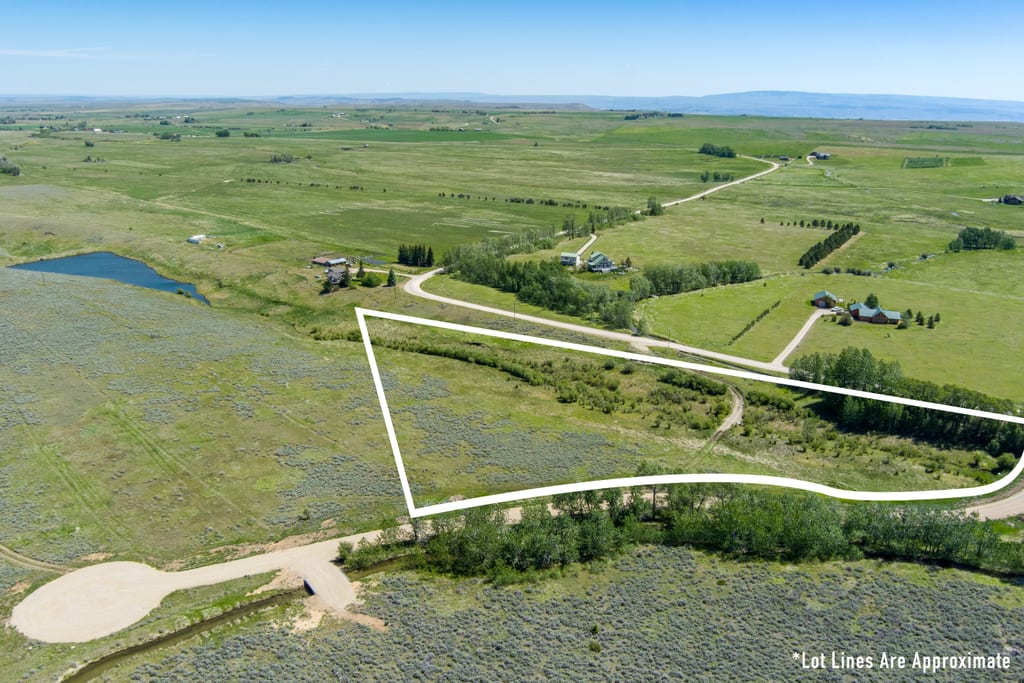 Aerial view of Lot 1 at East Bench Overlook with approximate boundary outline, pond and cul-de-sac nearby