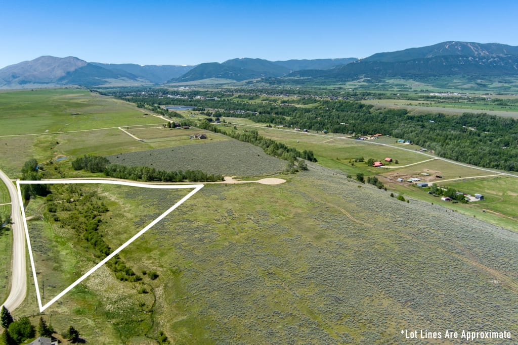 Aerial view of Lot 1 with approximate boundary outline and the mountain range beyond