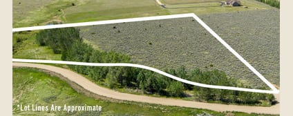 Aerial view southwest across Lot 2 toward the Beartooth Front, with the parcel boundary marked and Pleasant Valley Canal along the lower edge