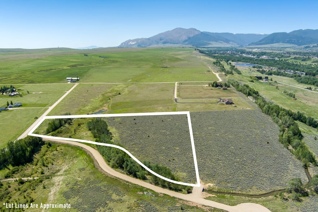 Pleasant Drive curving past Lot 2 with the green valley and mountain range beyond