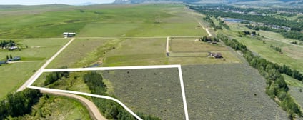 Pleasant Drive curving past Lot 2 with the green valley and mountain range beyond