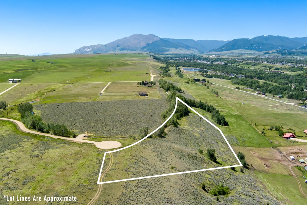 Aerial view of Lot 4 with approximate boundary outline and the mountain backdrop