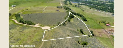Aerial view of Lot 4 with approximate boundary outline and the mountain backdrop