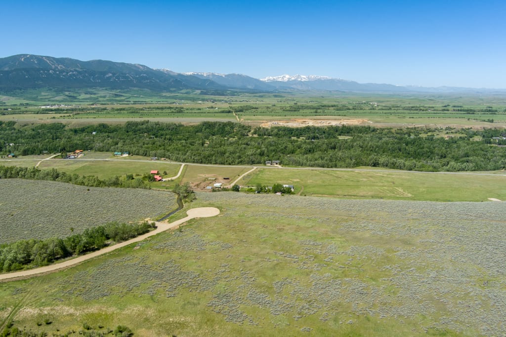 View across the east bench from Lot 5 toward distant high peaks