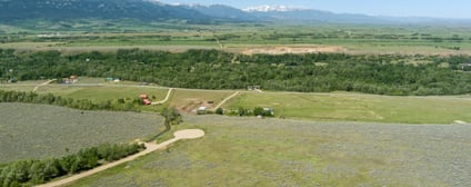 View across the east bench from Lot 5 toward distant high peaks