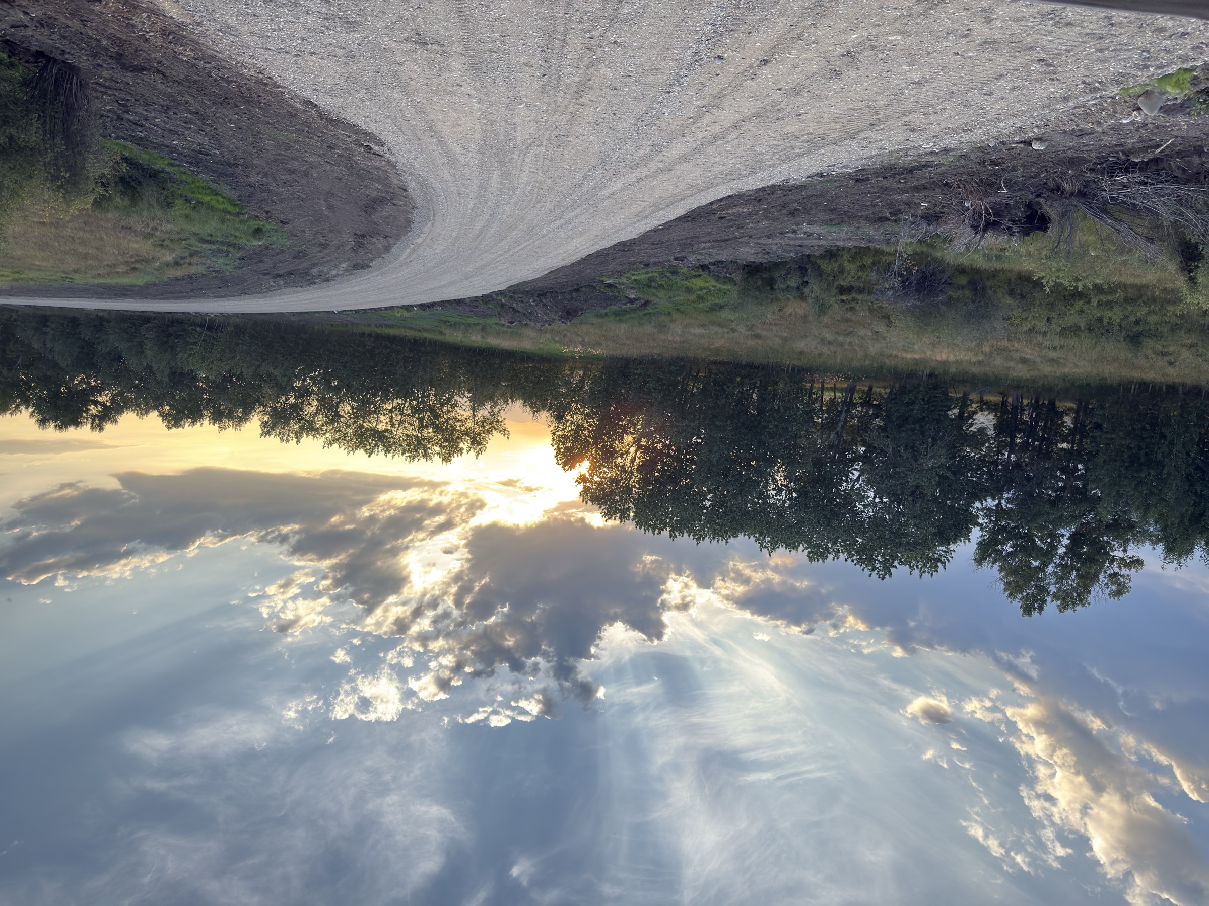 Gravel road curving through the east bench at sunset near Red Lodge, Montana